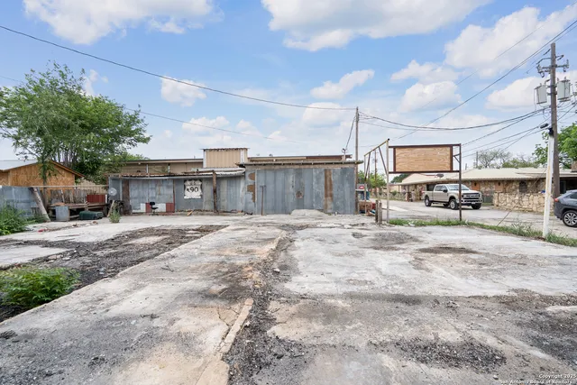 a backyard of a house with plants and outdoor seating