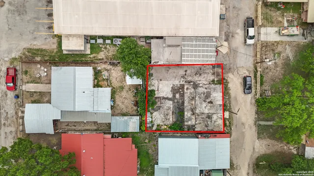 an aerial view of a house with a yard and lake view