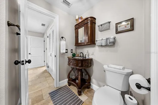a view of cabinets and utility room with wooden floor
