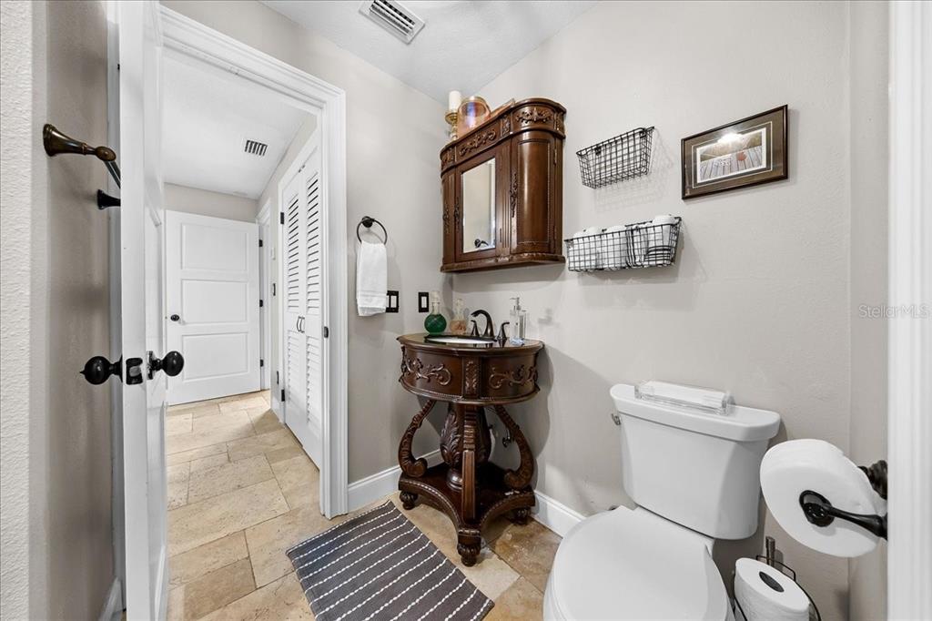 452 Southeast Paradise Point Road Crystal River, FL 34429 - Photo 11 of 83 a bathroom with a toilet a sink and mirror