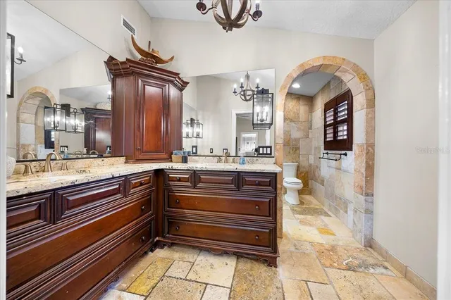 a view of a livingroom with wooden floor and a ceiling fan