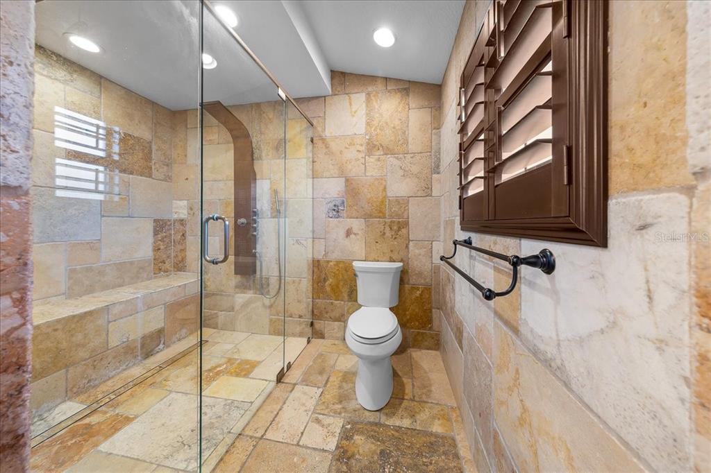 452 Southeast Paradise Point Road Crystal River, FL 34429 - Photo 16 of 83 a bathroom with a toilet sink and a shower