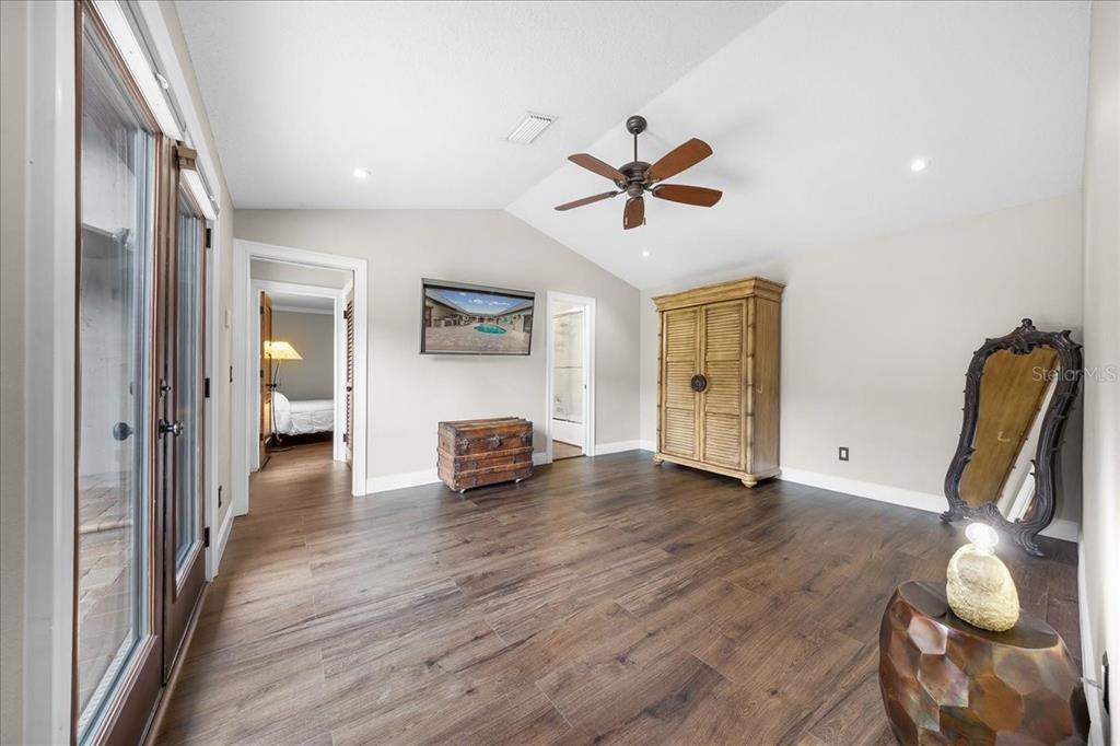 452 Southeast Paradise Point Road Crystal River, FL 34429 - Photo 18 of 83 a view of a livingroom with wooden floor and a ceiling fan