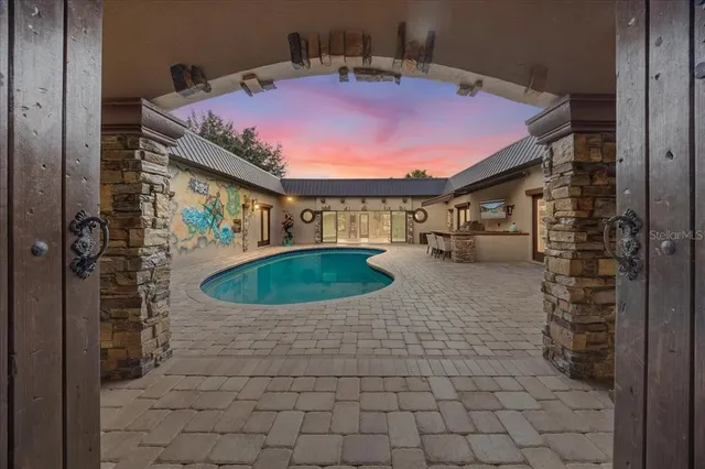an aerial view of a house with swimming pool