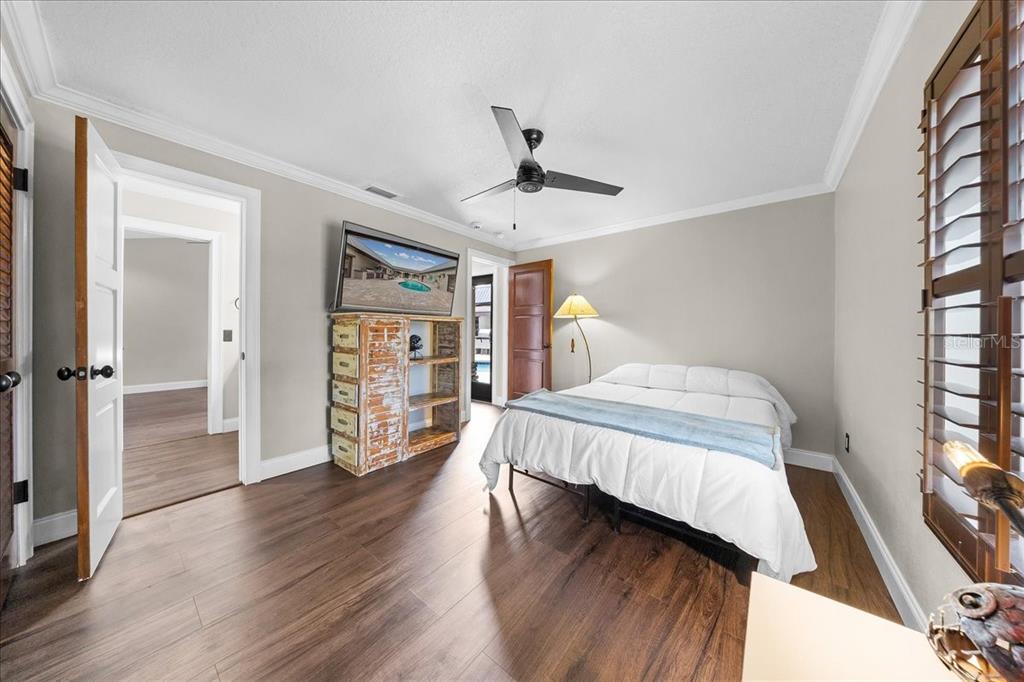 452 Southeast Paradise Point Road Crystal River, FL 34429 - Photo 24 of 83 a bedroom with a bed and wooden floor