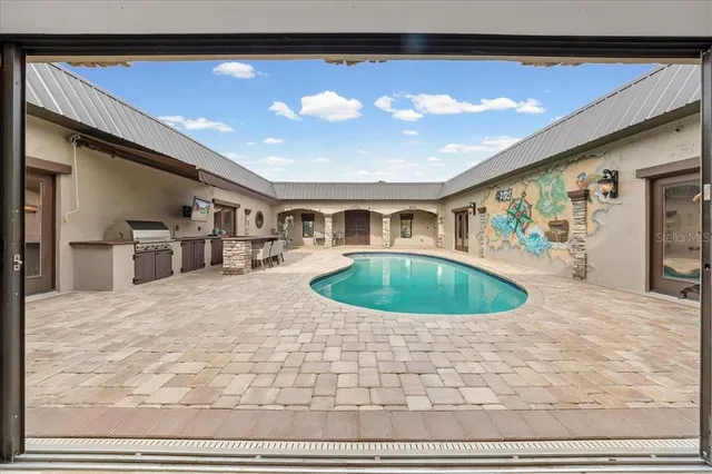 a kitchen with stainless steel appliances granite countertop a refrigerator and a stove top oven