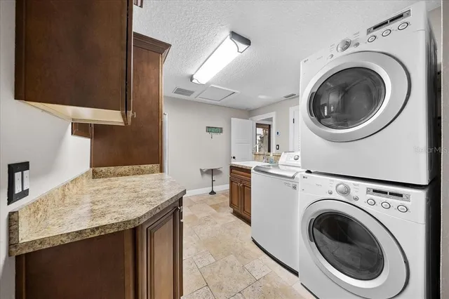 a kitchen with stainless steel appliances kitchen island granite countertop a sink stove and refrigerator
