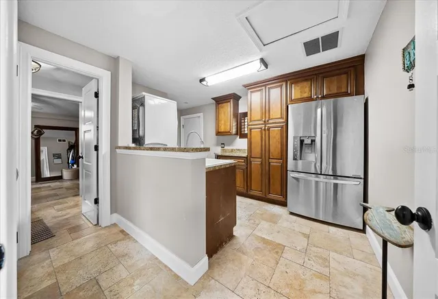 a view of a patio with table and chairs and potted plants
