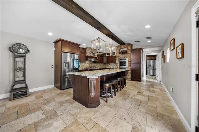 an aerial view of a swimming pool with outdoor seating and yard