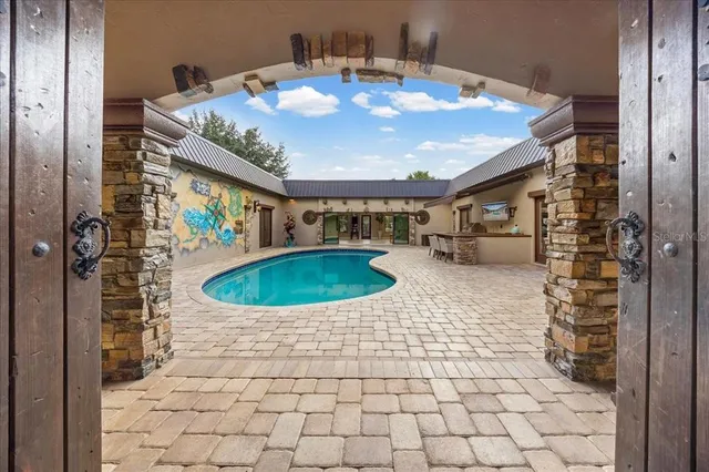 a spacious bedroom with a bed and a chandelier