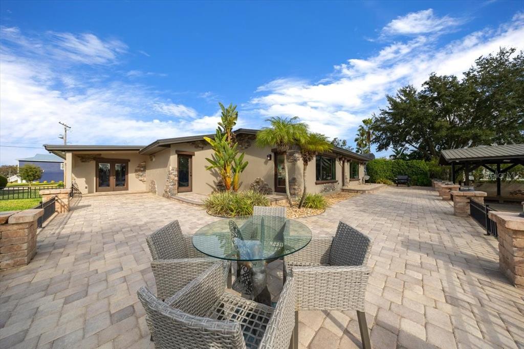 452 Southeast Paradise Point Road Crystal River, FL 34429 - Photo 62 of 83 a view of a patio with table and chairs and potted plants