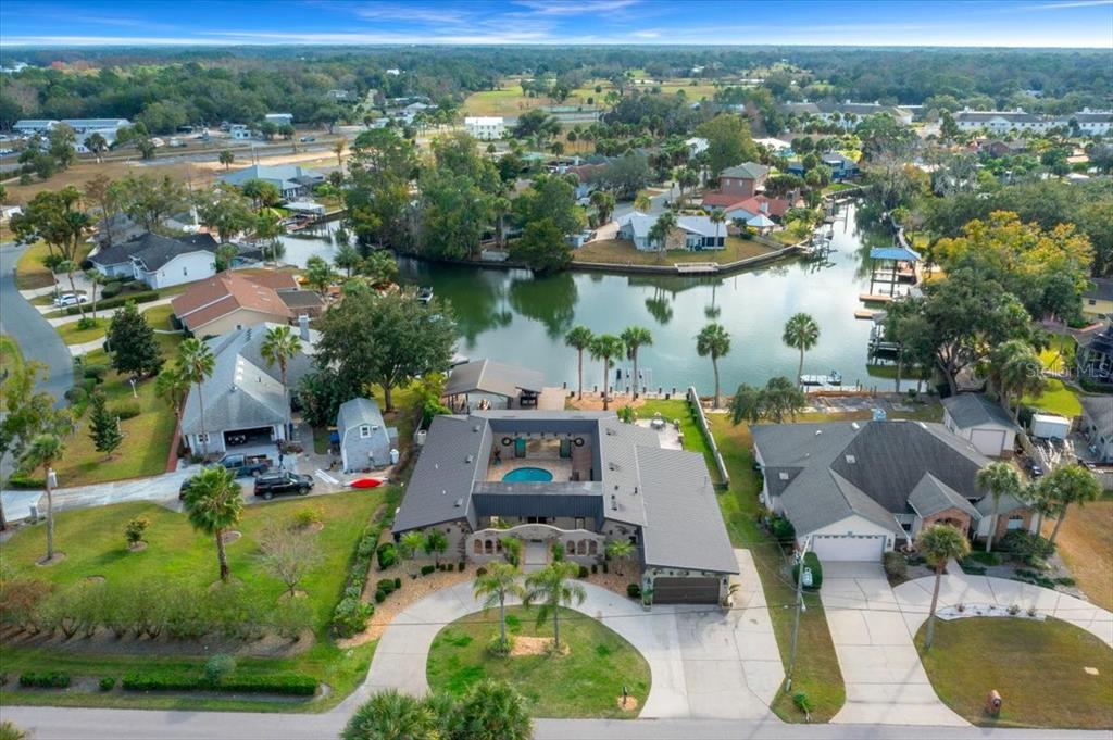452 Southeast Paradise Point Road Crystal River, FL 34429 - Photo 81 of 83 an aerial view of a swimming pool with outdoor seating and yard