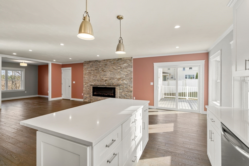 93 Providence Street, Unit B Mendon, MA 01756 - Photo 12 of 38 a view of an empty room with wooden floor and a fireplace