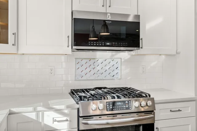 a stove top oven sitting inside of a kitchen