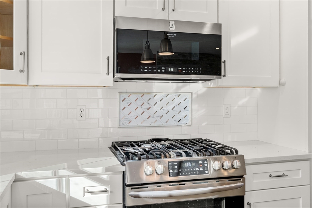 93 Providence Street, Unit B Mendon, MA 01756 - Photo 14 of 38 a stove top oven sitting inside of a kitchen