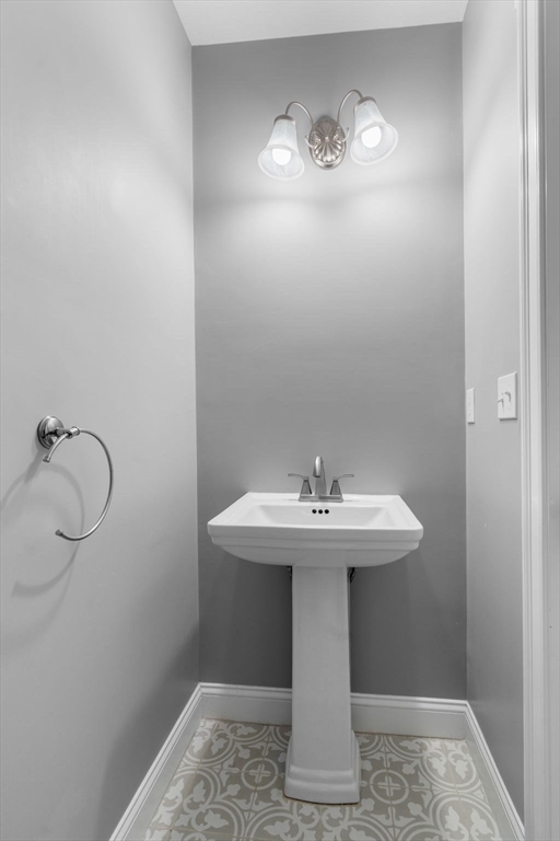 93 Providence Street, Unit B Mendon, MA 01756 - Photo 16 of 38 a bathroom with a sink toilet and mirror