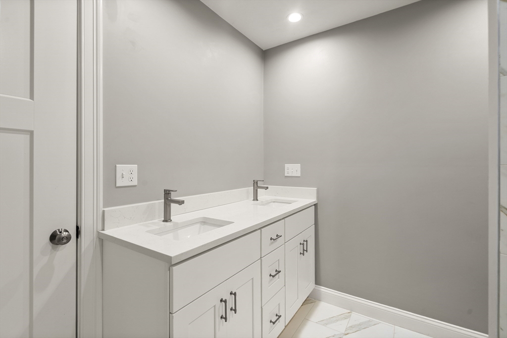 93 Providence Street, Unit B Mendon, MA 01756 - Photo 27 of 38 a bathroom with a sink and a mirror