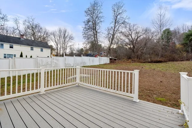 a view of a house with wooden deck