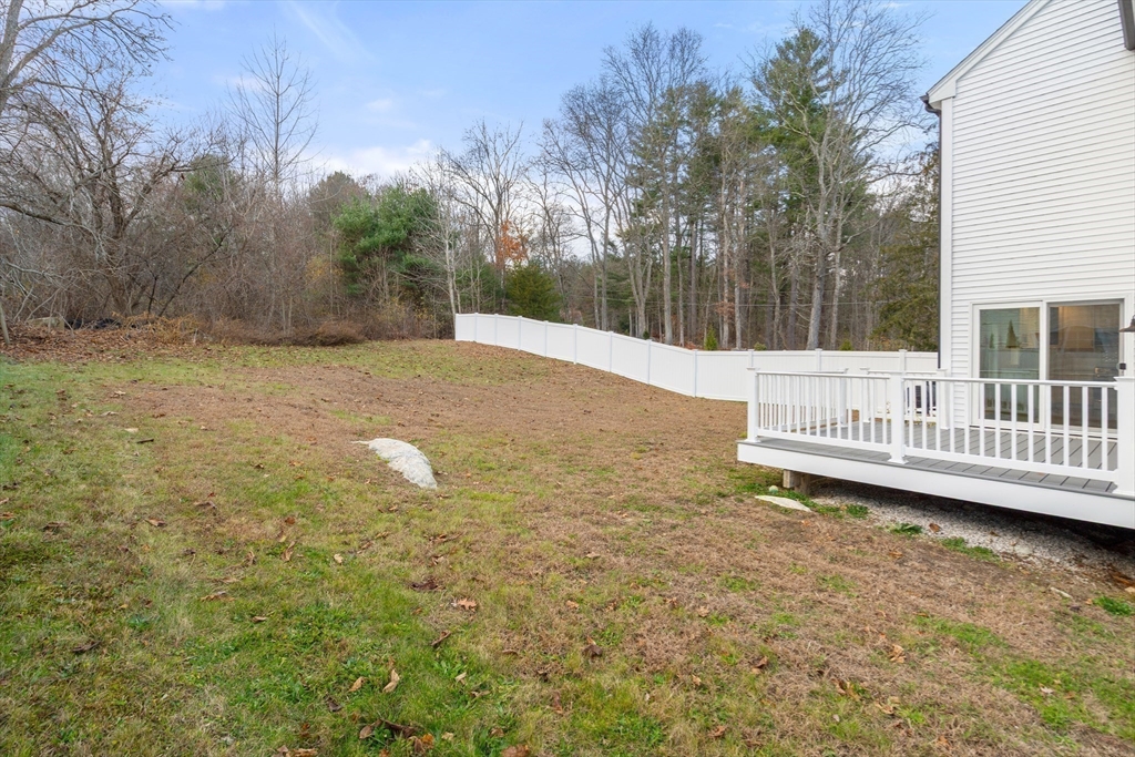 93 Providence Street, Unit B Mendon, MA 01756 - Photo 35 of 38 a view of a house with a yard and fence