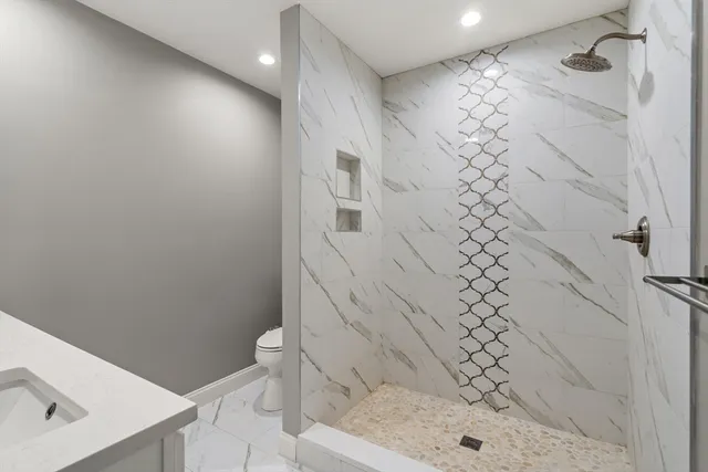 a bathroom with a shower toilet and sink