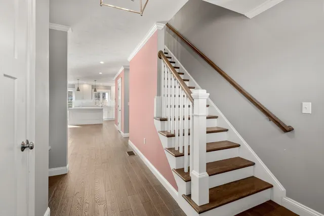 a view of entryway and hall with wooden floor