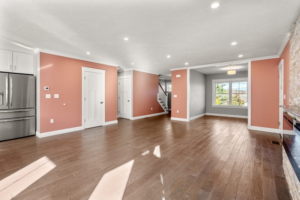 93 Providence Street, Unit B Mendon, MA 01756 - Photo 10 of 38 a view of an empty room with window and wooden floor