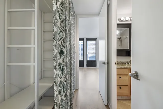 a view of a hallway with wooden shelves
