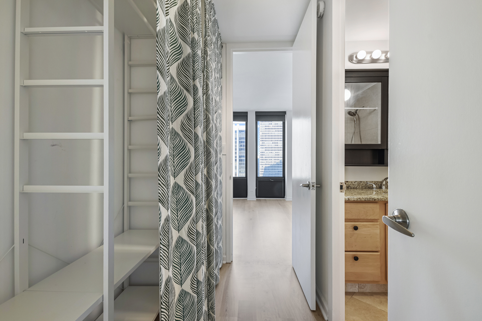 100 East Walton Street, Unit 26A Chicago, IL 60611 - Photo 11 of 23 a view of a hallway with wooden shelves