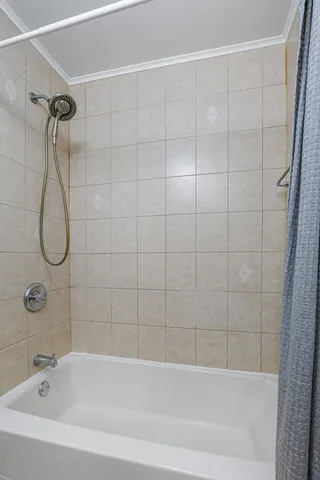 a bathroom with a bathtub and shower