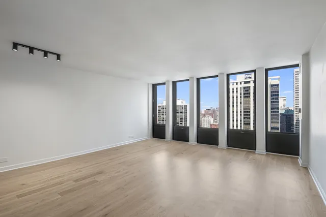 a view of an empty room with glass door