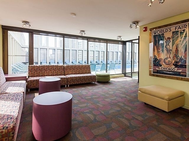 100 East Walton Street, Unit 26A Chicago, IL 60611 - Photo 22 of 23 a living room with furniture and a large window