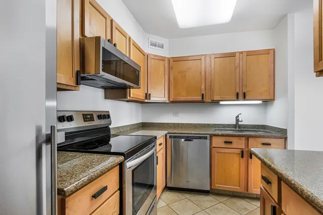 a kitchen with stainless steel appliances granite countertop a stove and a sink