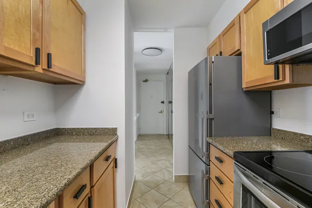 a kitchen with granite countertop a sink and a stove