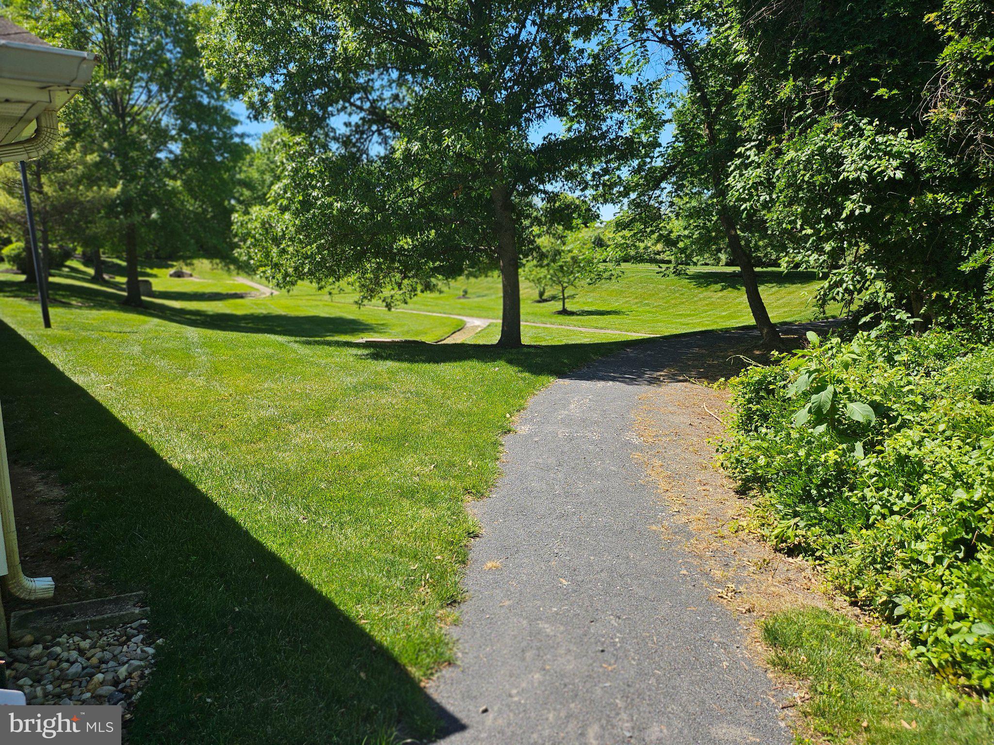 83 Kyle Way Ewing, NJ 08628 - Photo 31 of 36 Serene path through lush greenery.