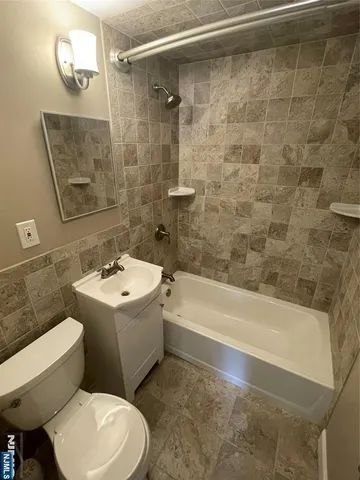 a bathroom with a sink a toilet and bathtub