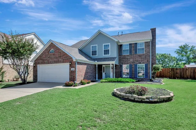 a view of a house with a yard and pathway
