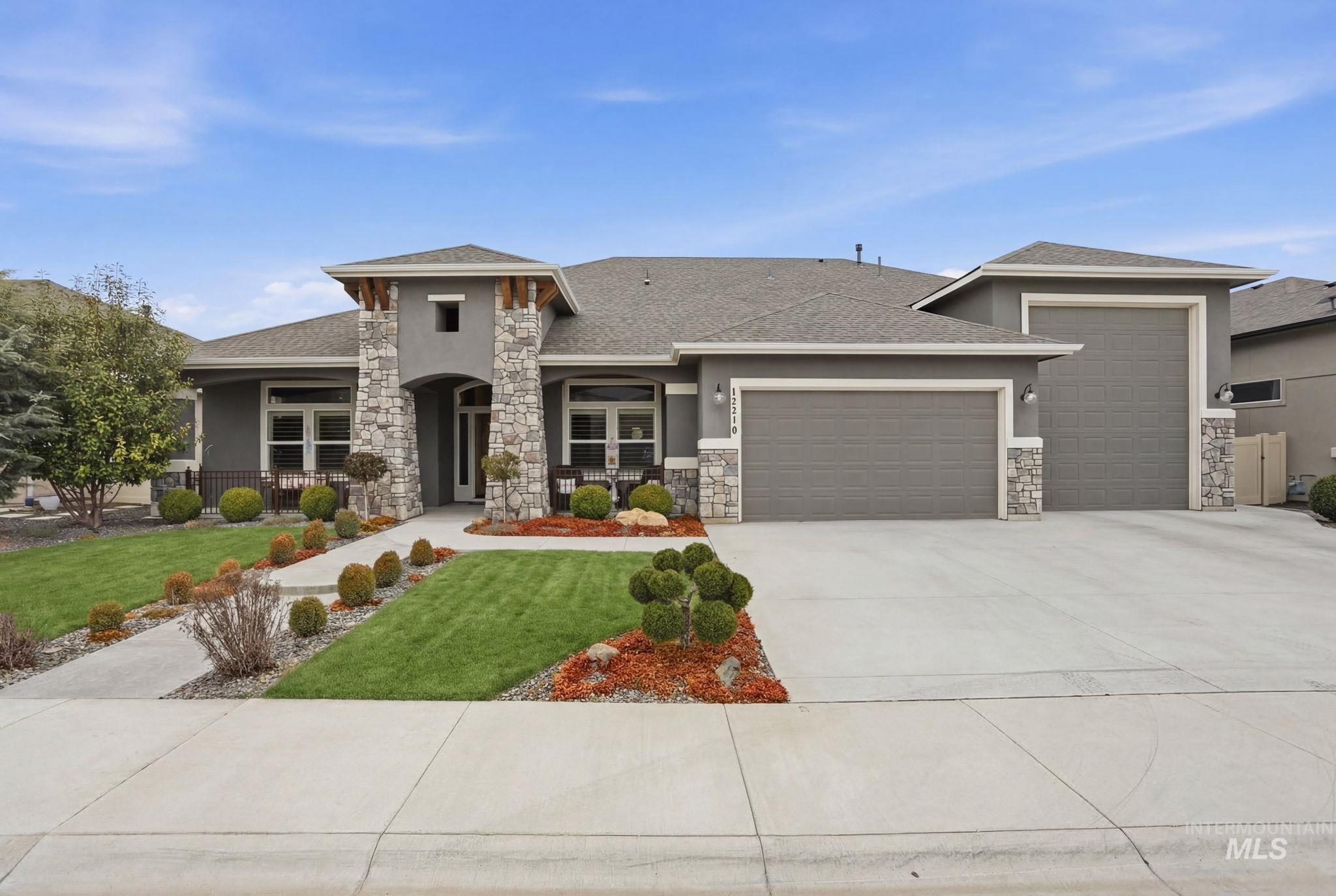 12210 West Lacerta Street Star, ID 83669 - Photo 1 of 1 Prairie-style house featuring a garage, stucco siding, a front yard, and roof with shingles