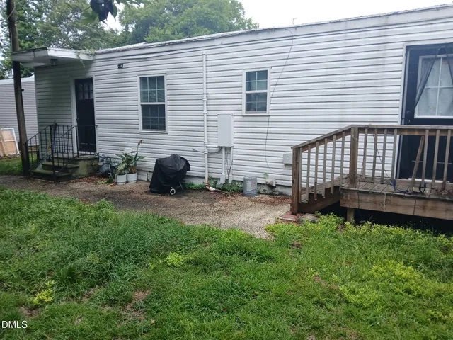 a backyard of a house with barbeque oven