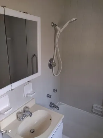a bathroom with a sink and mirror