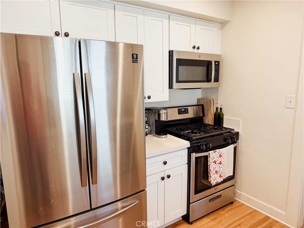 2714 Denton Street Riverside, CA 92507 - Photo 9 of 20 a kitchen with stainless steel appliances a stove a microwave and a refrigerator