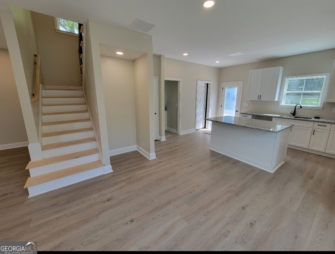 429 Ash Monroe, GA 30655 - Photo 3 of 9 a view of kitchen with cabinets and wooden floor