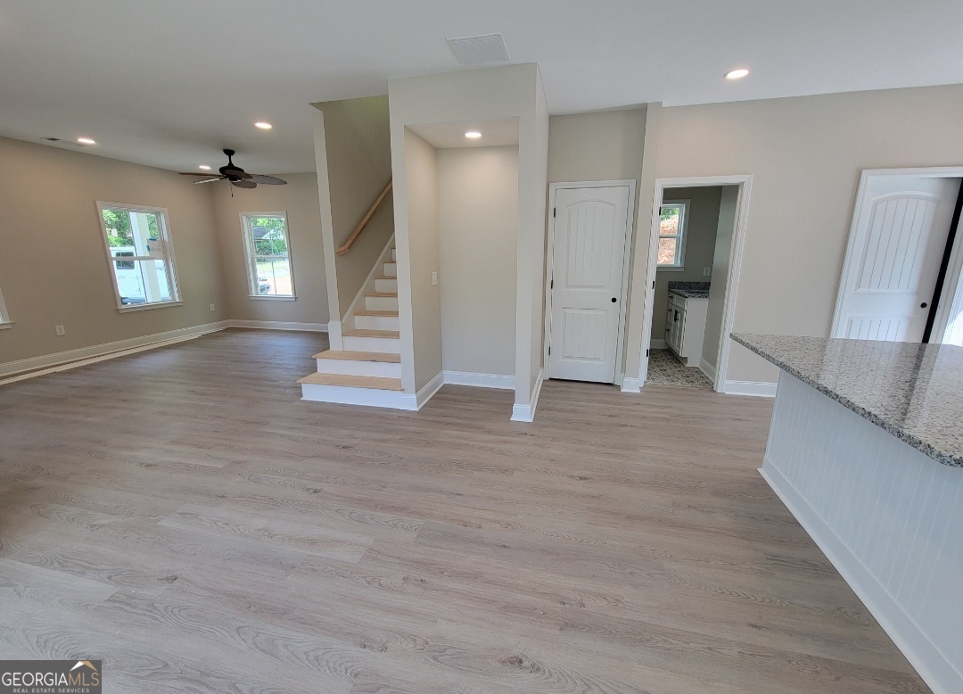 429 Ash Monroe, GA 30655 - Photo 5 of 9 a view of a hallway with stairs and a window
