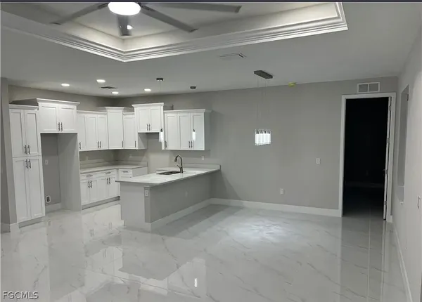 a large kitchen with kitchen island a sink stainless steel appliances and cabinets