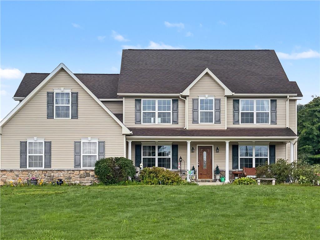 707 Gilbert Road Gilbert, PA 18331 - Photo 1 of 48 A welcoming front porch extends across this inviting two-story residence, featuring beige siding and a stone foundation.