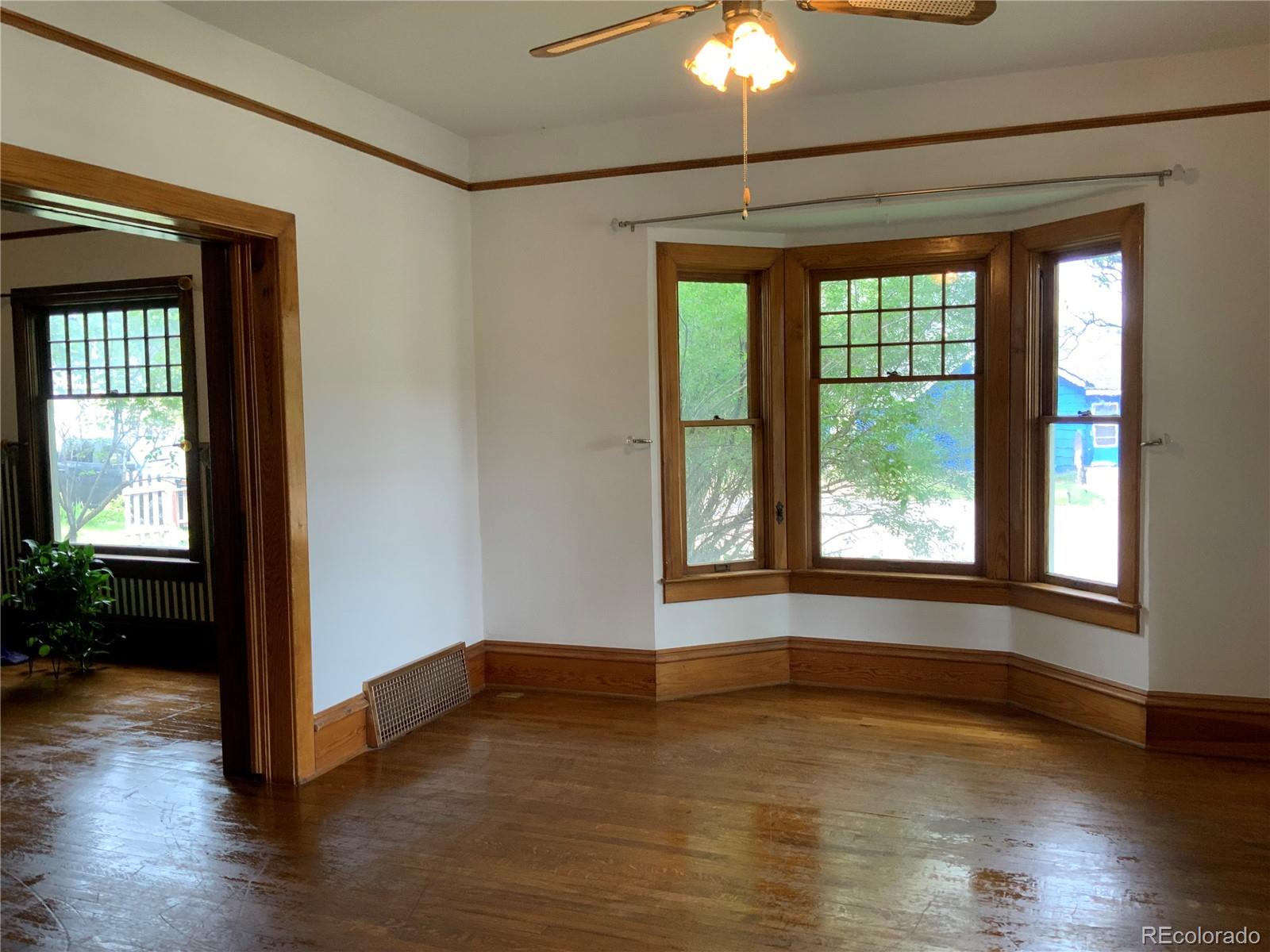 1011 Main Street Meeker, CO 81641 - Photo 4 of 28 a view of an empty room with wooden floor and a window