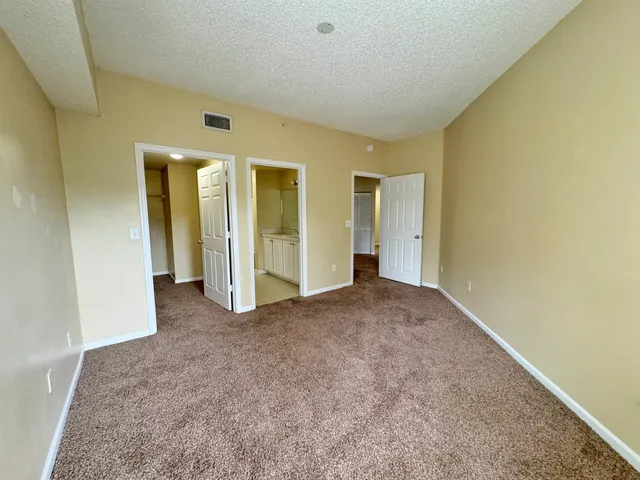 an empty room with closet and wooden floor