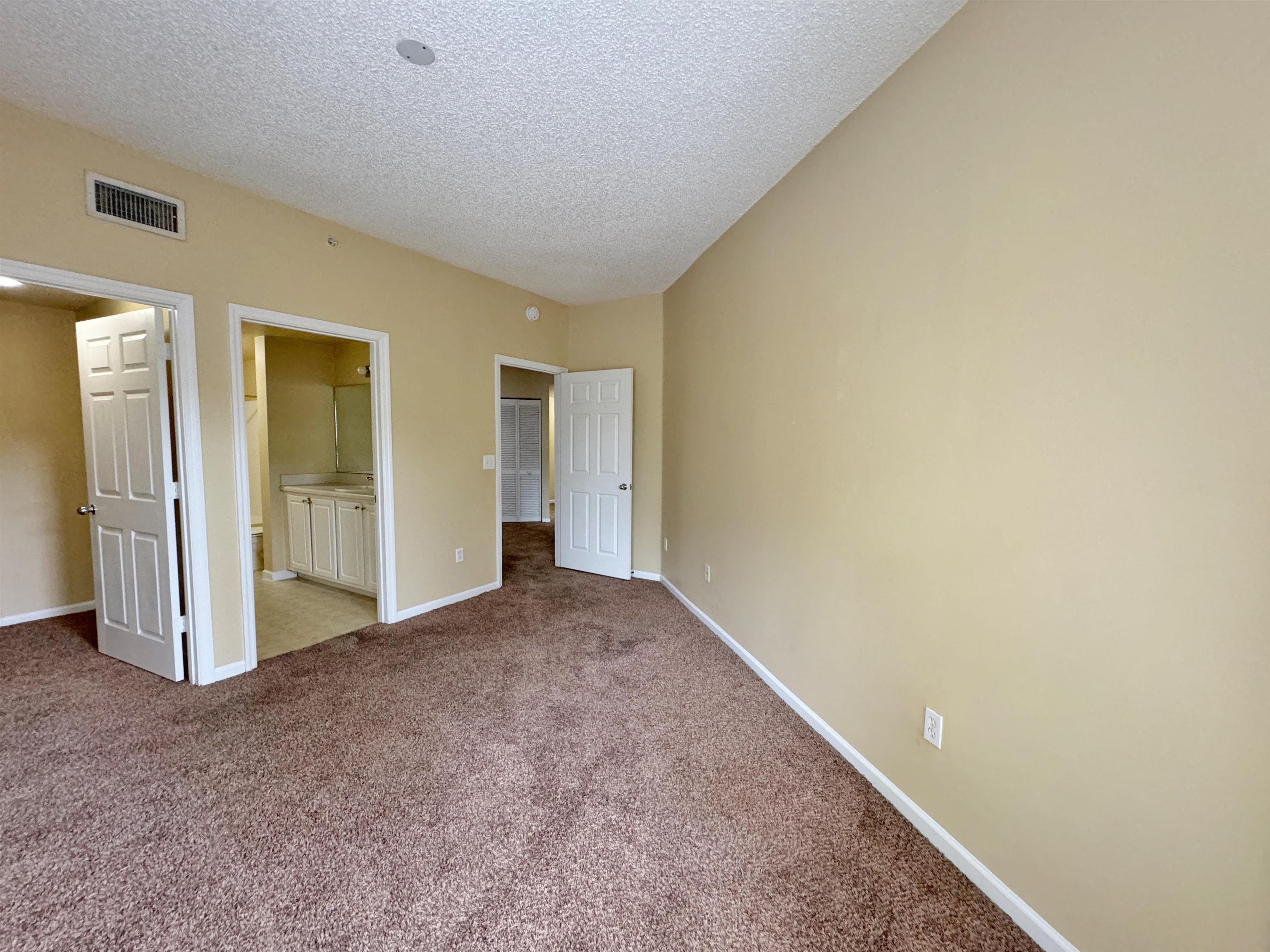 4035 Grande Vista Boulevard, Unit 201 St. Augustine, FL 32084 - Photo 12 of 28 an empty room with closet area