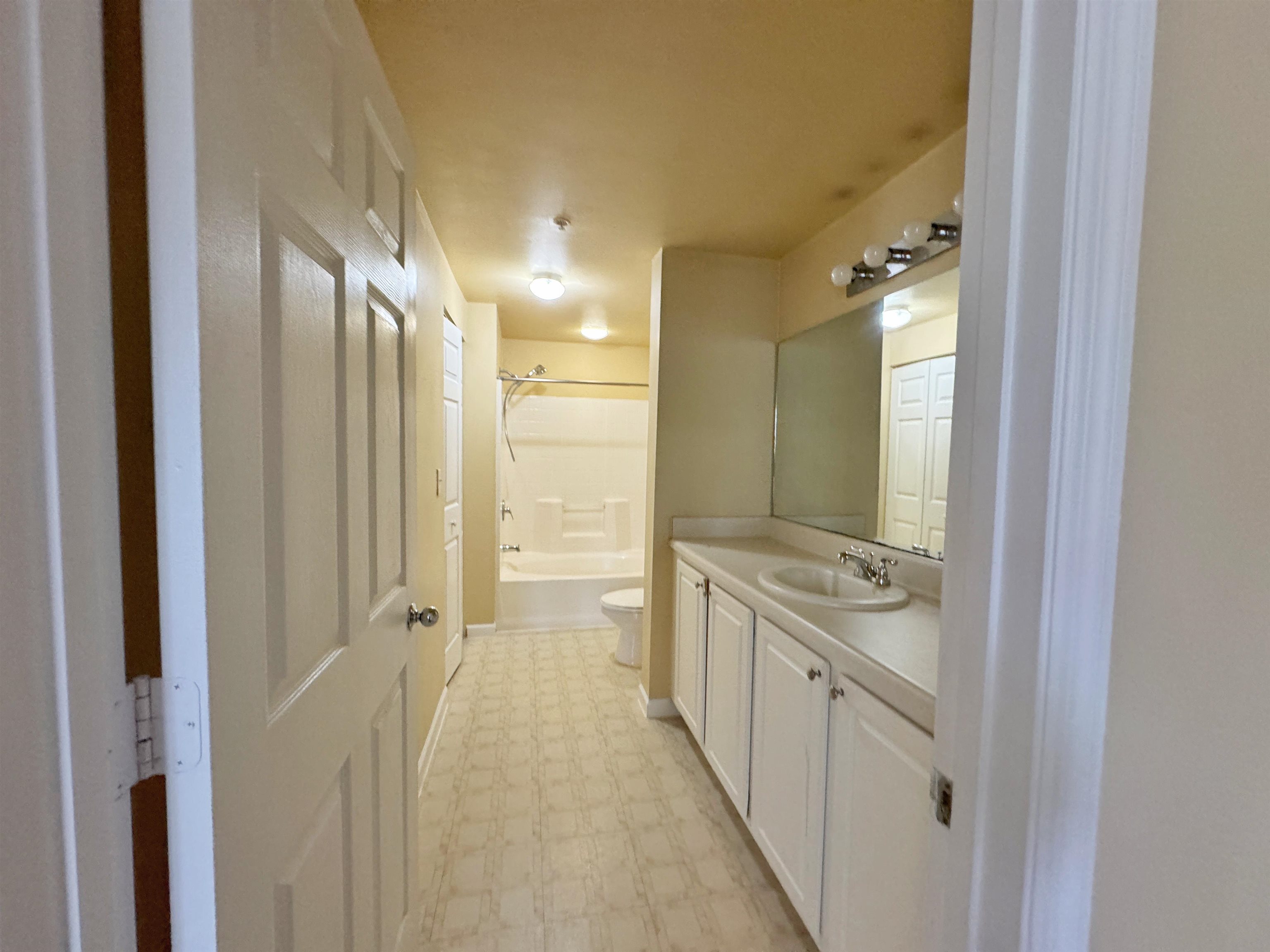 4035 Grande Vista Boulevard, Unit 201 St. Augustine, FL 32084 - Photo 13 of 28 a bathroom with a double vanity sink toilet and shower
