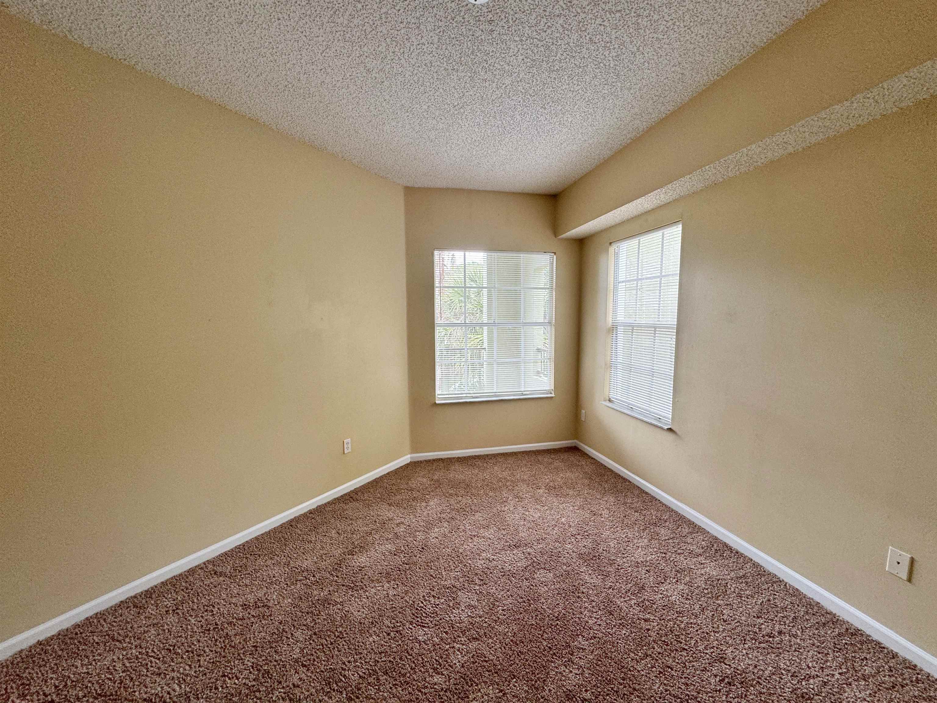 4035 Grande Vista Boulevard, Unit 201 St. Augustine, FL 32084 - Photo 9 of 28 an empty room with windows