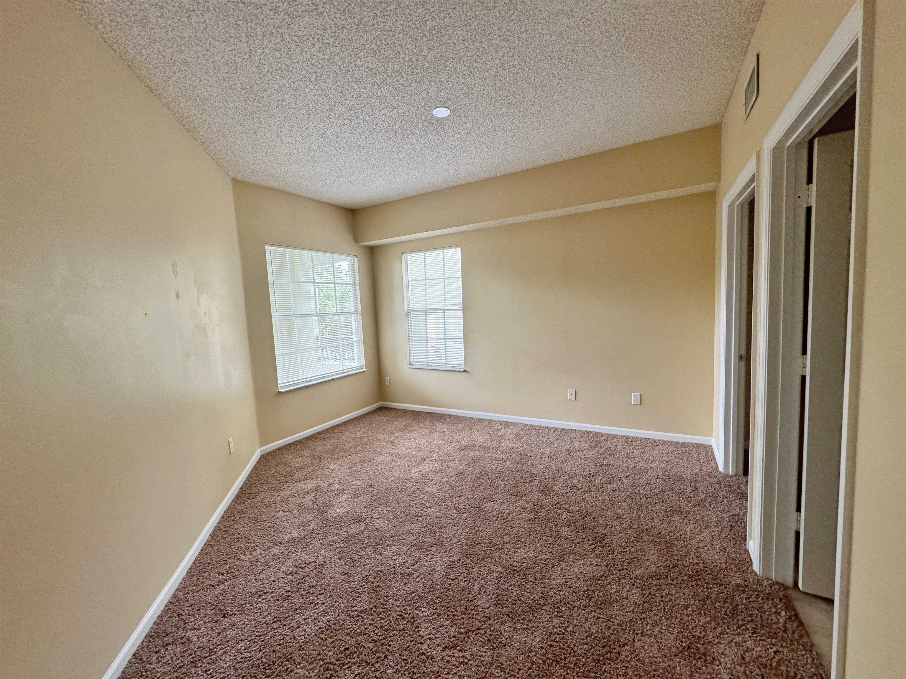 4035 Grande Vista Boulevard, Unit 201 St. Augustine, FL 32084 - Photo 10 of 28 an empty room with windows and closet